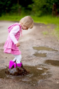little girls kicking mud