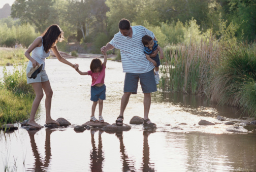 family walking on rocks