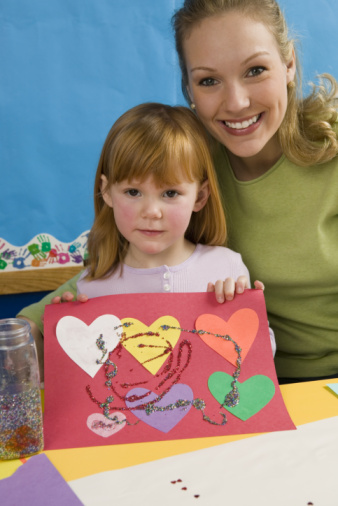 little girl making crafts