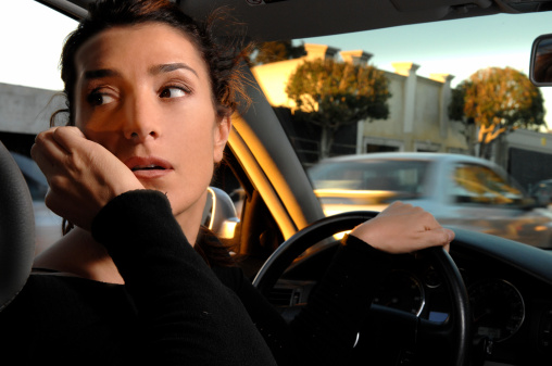 Lady on phone driving a car