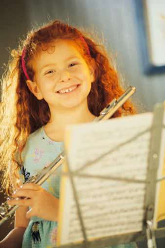 little girl playing the flute