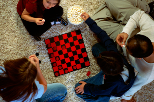 family playing checkers