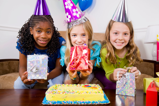 Girls holding birthday presents