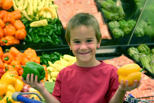 Kids holding vegetables