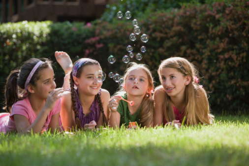 4 girls blowing bubbles