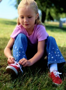 Little Girl Tieing Her Shoes