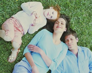 Family laying on grass