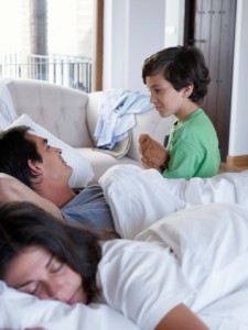 Little boy in bed with parents