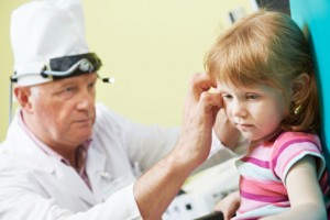 Doctor checking a girls ear