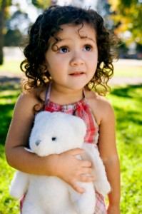 Girl holding a white teddy bear