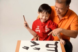 small boy with grandfather painting