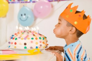 Boy blowing out birthday candles