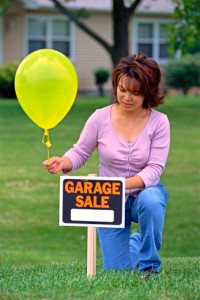 lady with garage sale sign