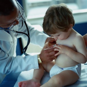 child touching a doctors stethescope