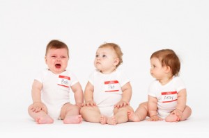 babies sitting in a row with name tags